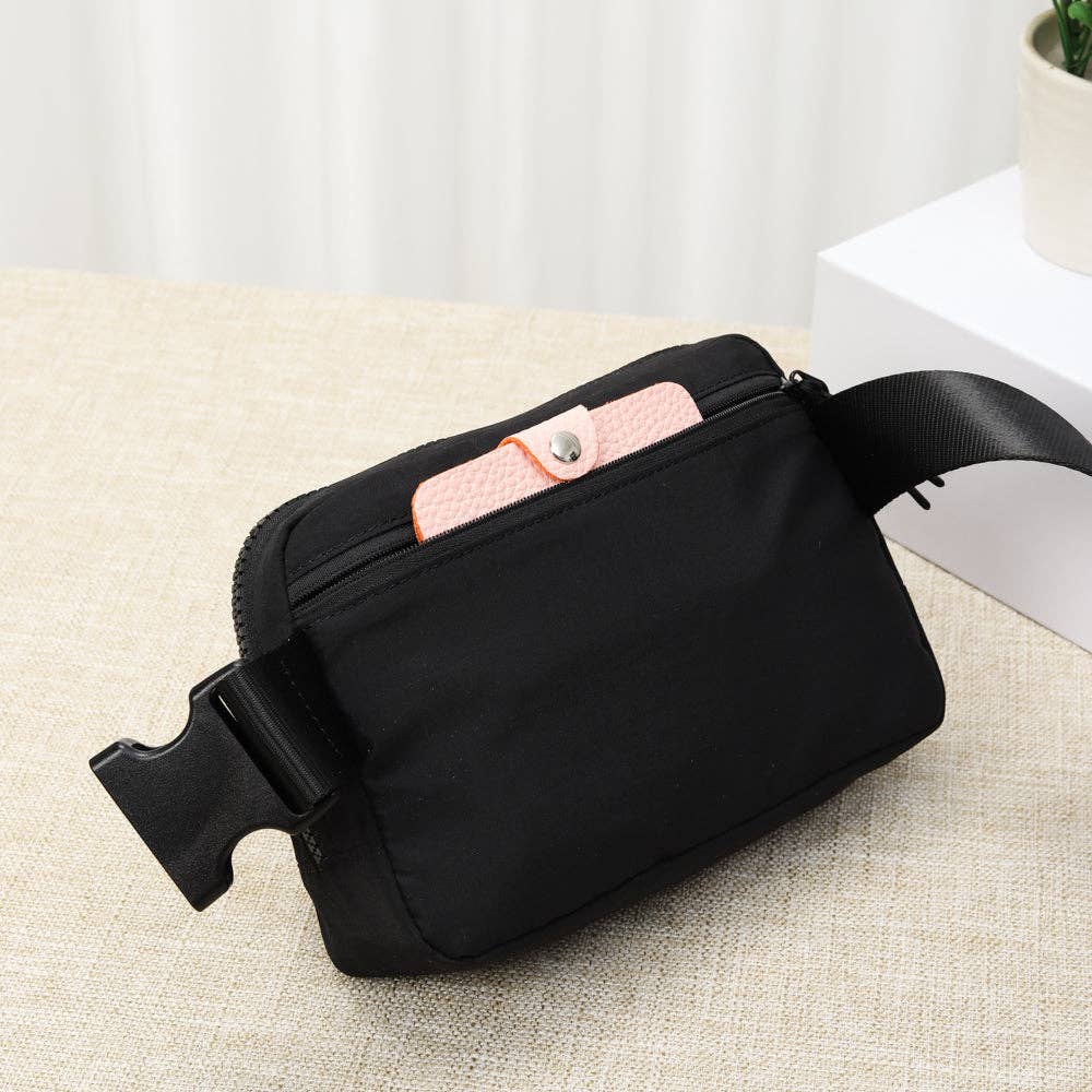 Black Fanny Pack Crossbody Belt Bag with a pink phone inside
