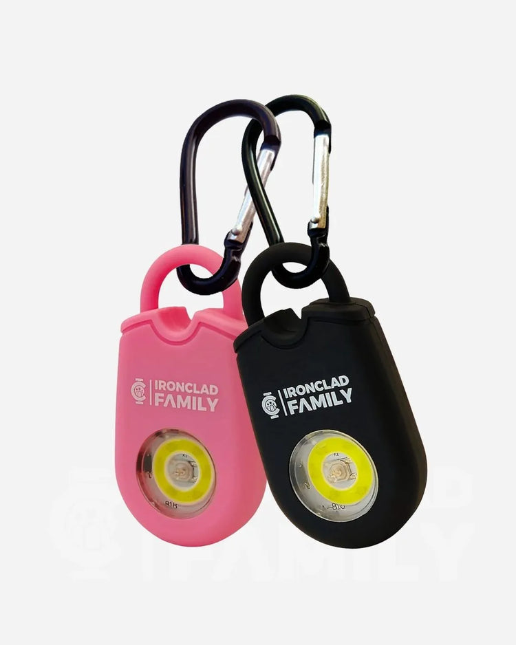 Two pink personal alarm keychains with black LED lights and a carabiner