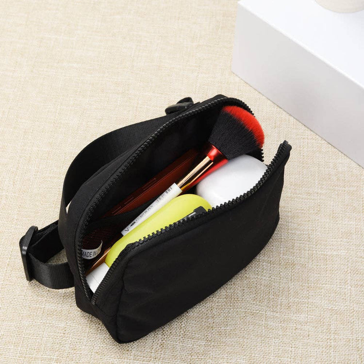 Black Crossbody Belt Bag with various items inside