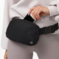 Woman utilizing the black waterproof waist bag to hold her phone