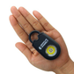 Hand holding personal alarm sound pendant keychain with flashlight feature