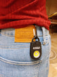 Person carrying the Personal Alarm Sound Pendant Keychain in their pocket