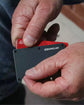 Man holding a Matte Metal RFID Blocking Wallet with red and black design