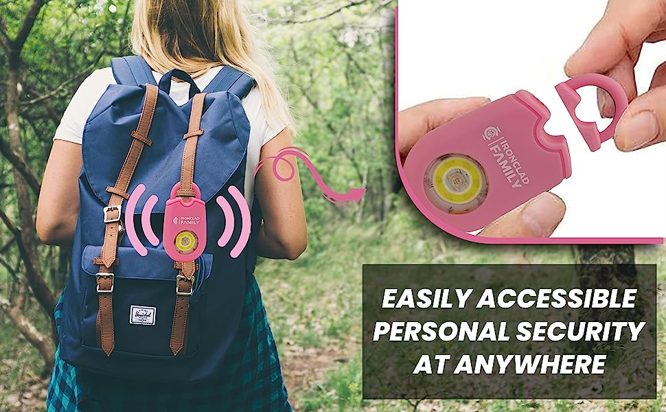 A woman with a backpack featuring a pink personal alarm keychain