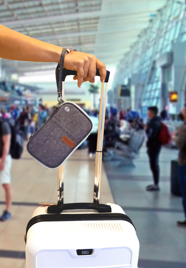 Individual carrying a suitcase with an attached RFID blocking travel case